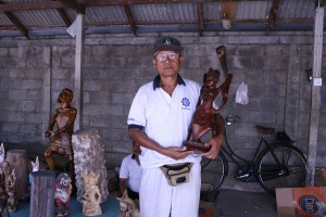 Men make traditional wooden statues in Bali.