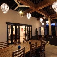 Holiday villa in Bali with covered terrace with lounge area and a cozy long dining table.