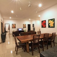 The holiday villa in Bali has a dining area with a large table.