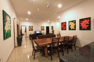 The holiday villa in Bali has a dining area with a large table.