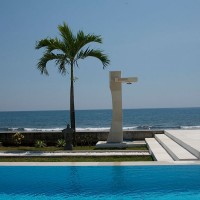 After swimming, rinse under the outdoor shower overlooking the Bali sea.
