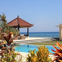 Swimming pool at holiday villa in Bali with lounge area.