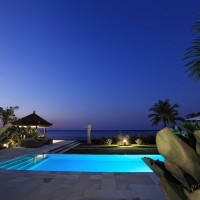 The pool of our holiday villa in Bali is lit up at night.